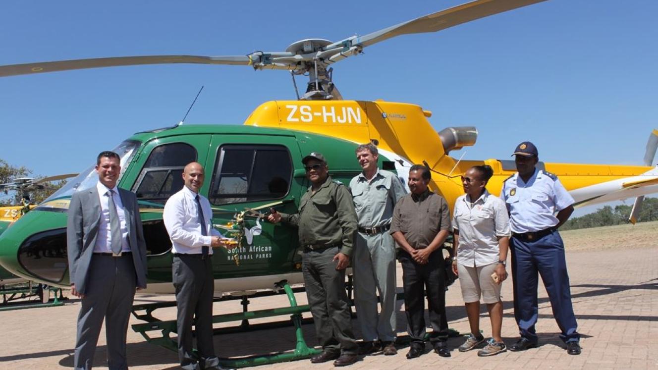 The Chairperson of SANParks Board, Kuseni Dlamini, cuts the ribbon to officially receive the new helicopter. He’s flanked by (clockwise) Gilberto do Nascimento from Airbus Southern Africa; Arnaud Montalvo, CEO of Airbus Helicopters Southern Africa; the KNP Acting Managing Executive, Danie Pienaar; SANParks CFO, Rajesh Mahabeer; Rose Masela from the Department of Environmental Affairs; and Deputy Provincial Commissioner Mpumalanga, Major General Phahla.