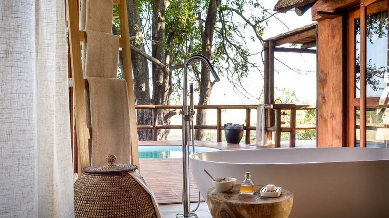 Sanctuary Chief’s Camp’s new bathrooms, which have floor-to-ceiling windows and folding glass doors, also have an outdoor shower and large bathtub.