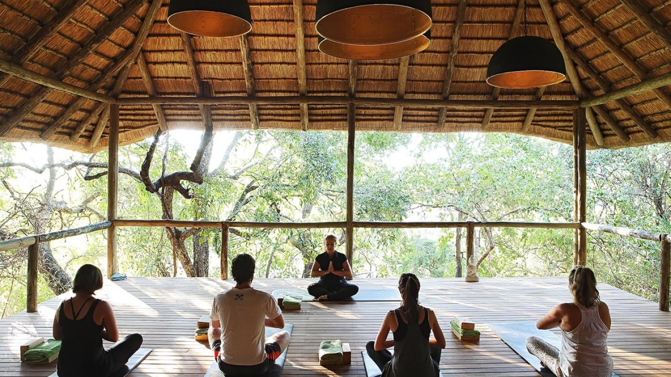 Facing the demands of modern-day society, more and more travellers are opting for wellness experiences when visiting southern and East Africa. Image: Safari yoga at Londolozi.