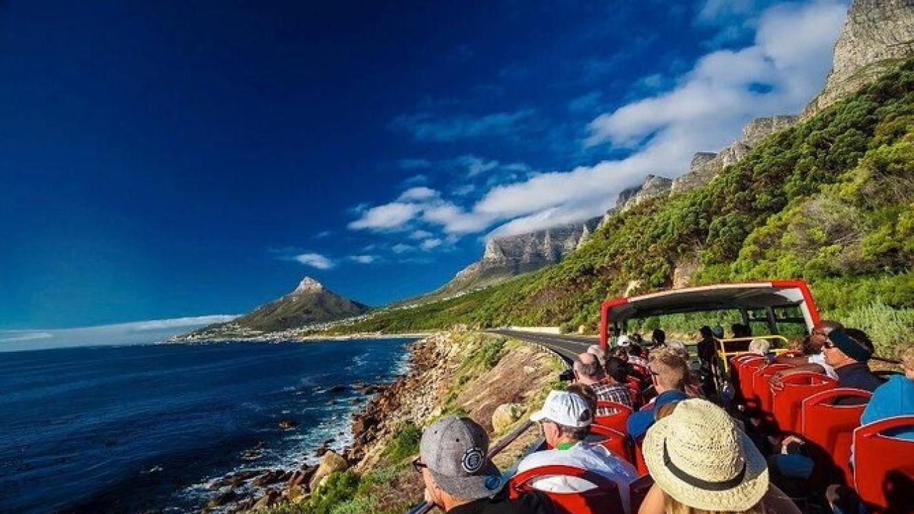 Tourists on an open-top sightseeing bus in Cape Town.