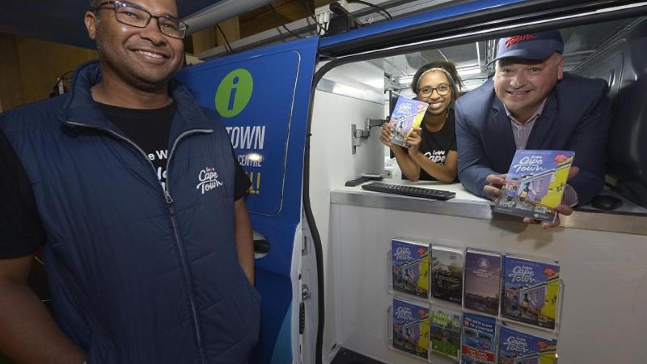 James Vos (far right) shows off the new pocket-friendly guides.