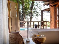 Sanctuary Chief’s Camp’s new bathrooms, which have floor-to-ceiling windows and folding glass doors, also have an outdoor shower and large bathtub.