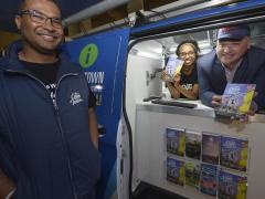 James Vos (far right) shows off the new pocket-friendly guides.