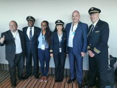 James Vos (second from right) poses with the crew of the new United Airlines flight to New York.