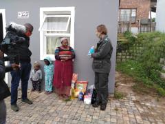 Deputy Mayor, Aubrey Tsengwa and Park Manager for Knysna, Megan Taplin, with the first recipient to receive groceries in Dam se Bos.